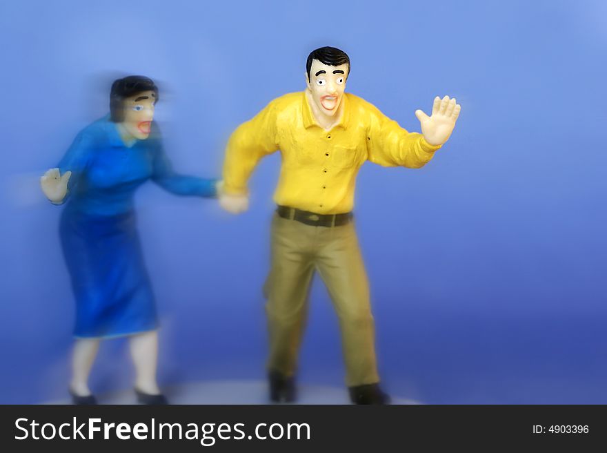 Man and a woman holding hands, moving forward with scared expression on faces. Man and a woman holding hands, moving forward with scared expression on faces