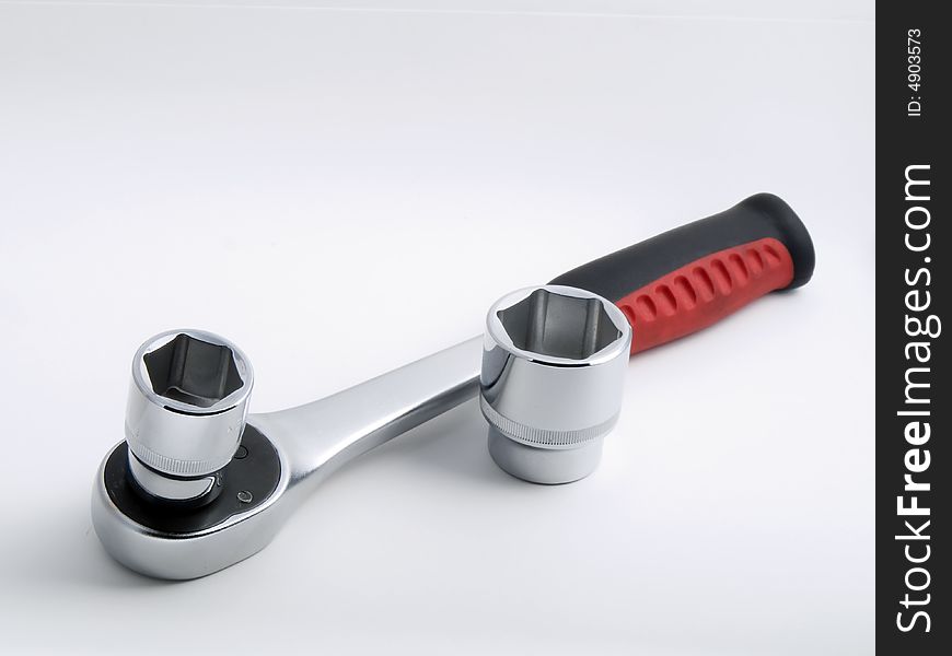 Socket wrench against white background with two extensions.