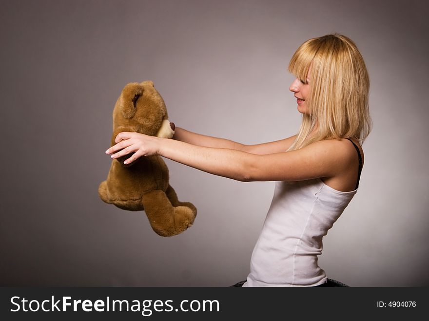 Girl with toy, gray background