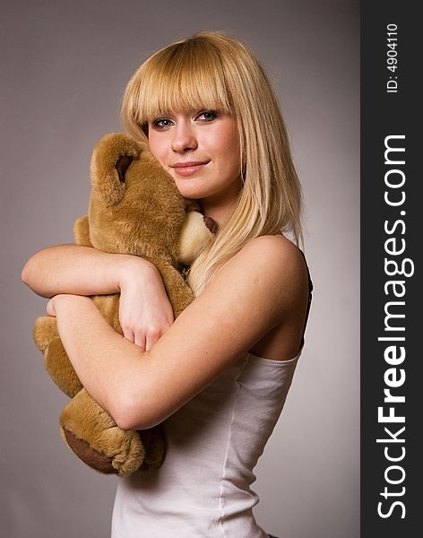 Girl with toy, gray background