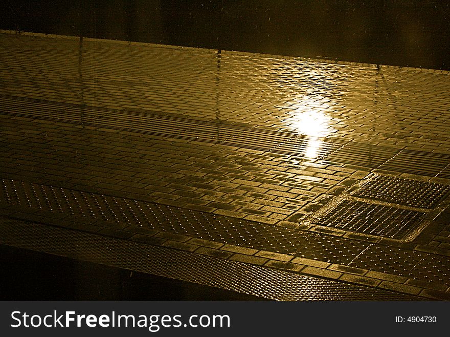 reflected rain in a sidewalk