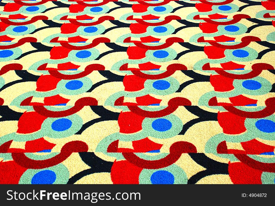 An old felt carpet of colorful regular patterns. An old felt carpet of colorful regular patterns