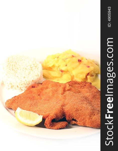 Traditional  viennese Schnitzel with potato salad and rice on a withe background.