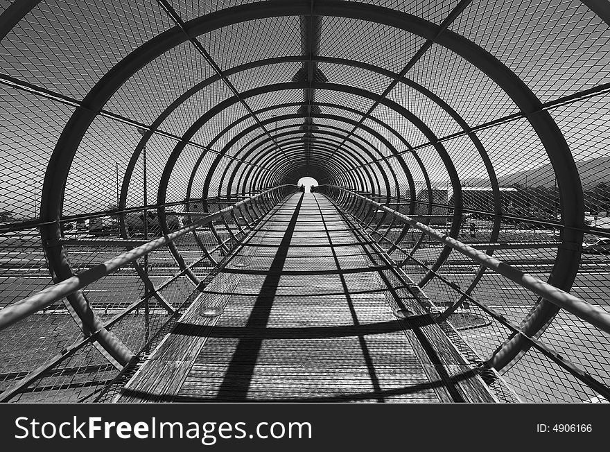 Footbridge over highway with arcs, black and white image. Footbridge over highway with arcs, black and white image