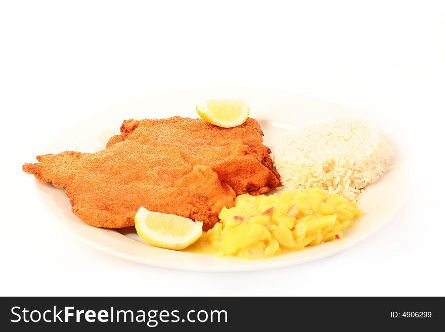 Traditional  viennese Schnitzel with potato salad and rice on a withe background.