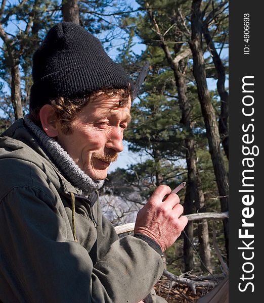 A portrait of a smoking men with stocking cap on his head. Russian Far East, Primorye. A portrait of a smoking men with stocking cap on his head. Russian Far East, Primorye.