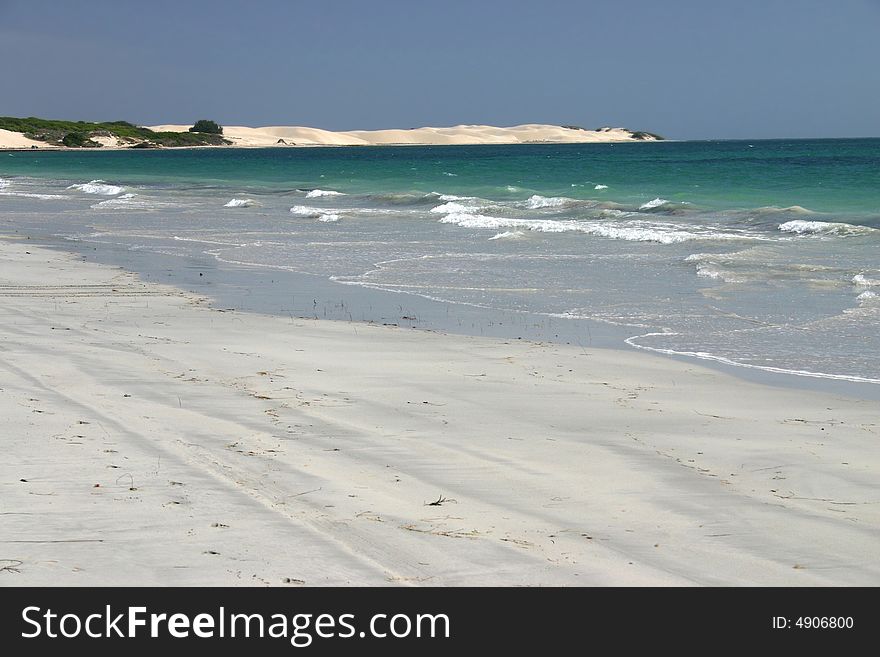 Wide angle shot of idyllic sandy beach with clear blue sky. Australia