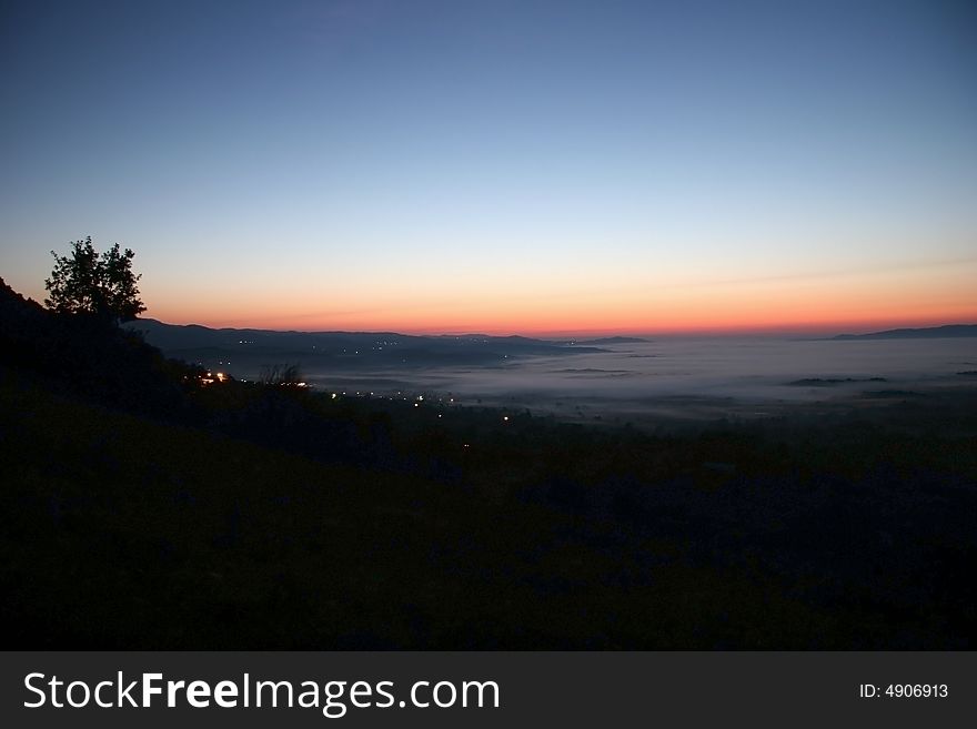 High-wide angle shot of a beautiful dusk scene over the village. Bela Krajina. Slovenia