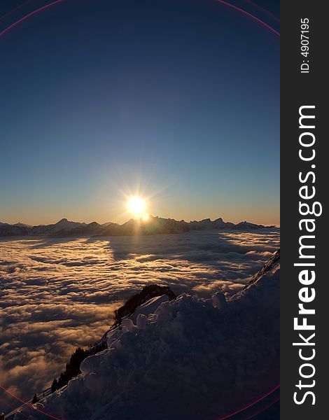 A sun setting over the swiss alps. A sun setting over the swiss alps