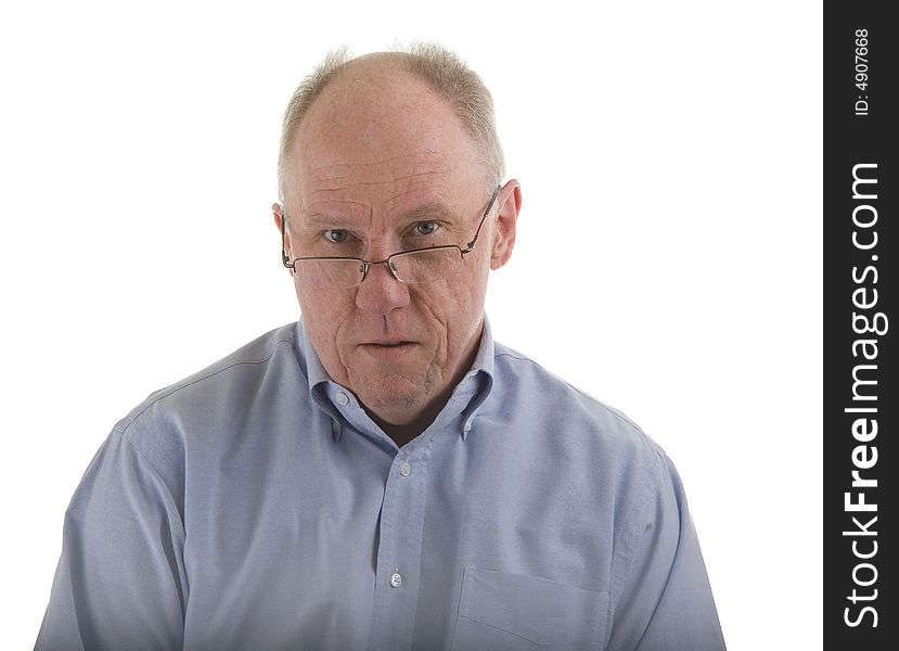 An older guy in a blue shirt and glasses, looking over the rims. An older guy in a blue shirt and glasses, looking over the rims