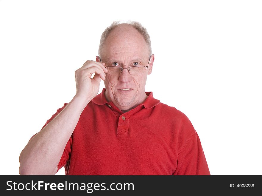 An older bald guy in a red shirt holding his reading glasses. An older bald guy in a red shirt holding his reading glasses