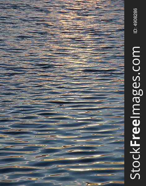 The sun setting reflecting off the waters surface. The sun setting reflecting off the waters surface