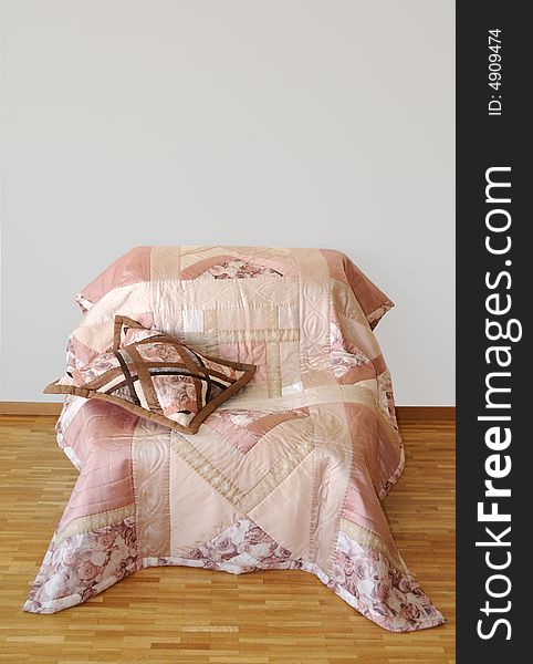 Sofa covered patchwork quilt draped with pillow. Sofa covered patchwork quilt draped with pillow
