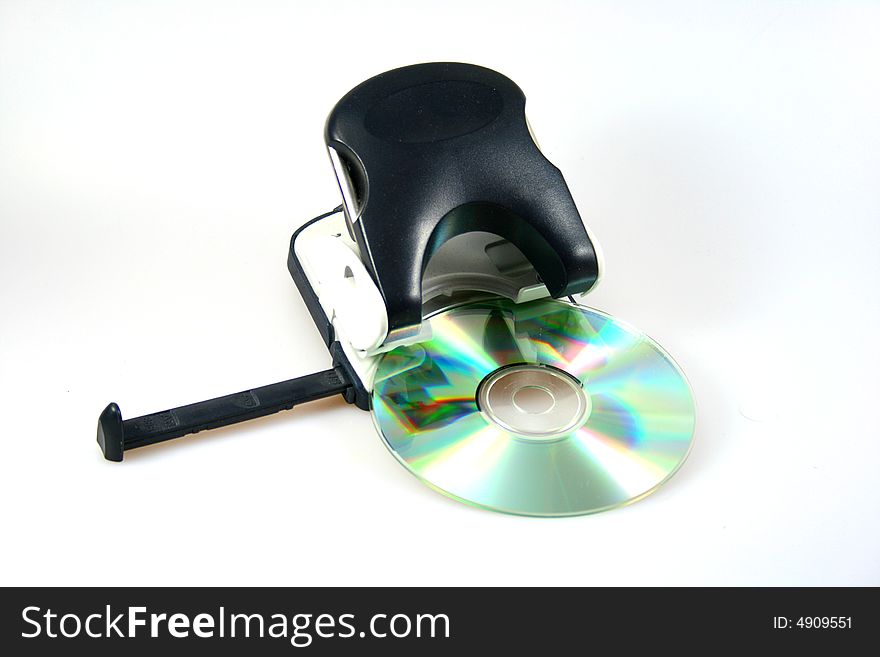 Black perforator with cd or dvd as symbol for office stuff or creative objects. Black perforator with cd or dvd as symbol for office stuff or creative objects.