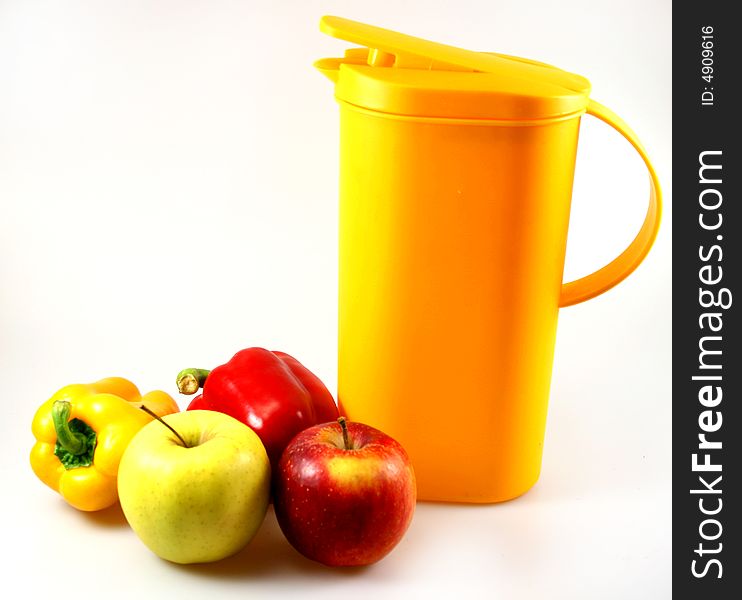 Some apples, paprika and one carafe in red green and yellow as light snack. Some apples, paprika and one carafe in red green and yellow as light snack