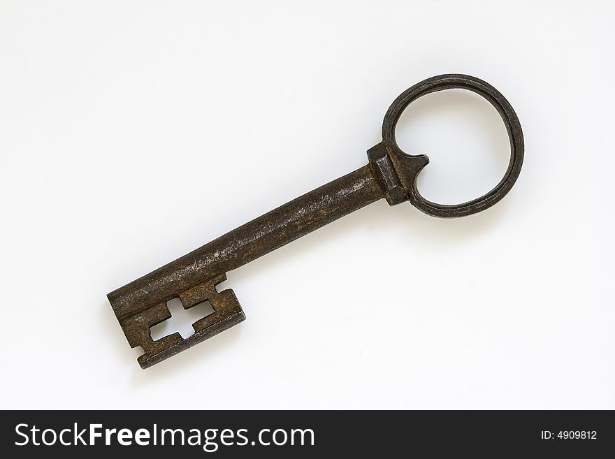 Vintage rusty key isolated at white