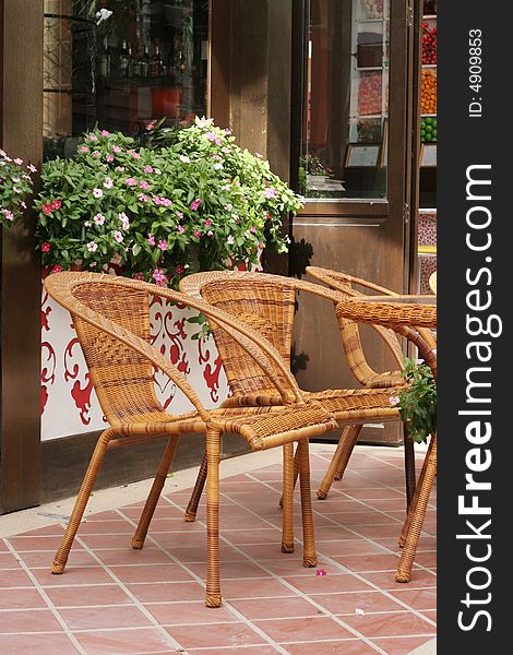 Cane chairs in an outdoor seating area. Cane chairs in an outdoor seating area.