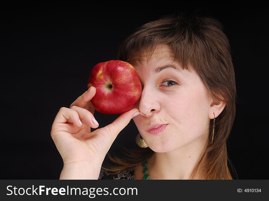 Woman with apple near her eyes. Woman with apple near her eyes