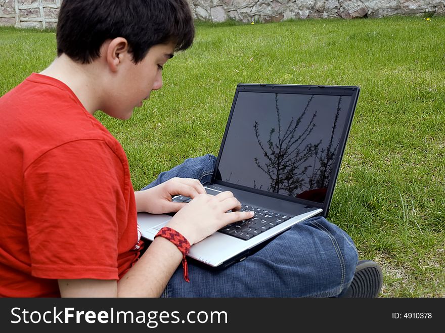 Human hand pressing a key on a laptop keyboard. Human hand pressing a key on a laptop keyboard