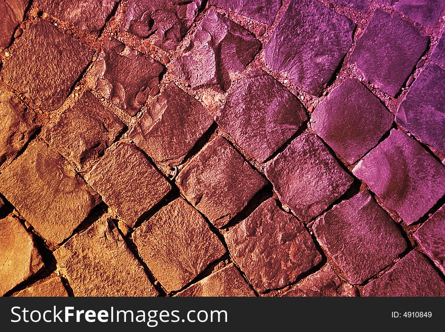 Red and violet road covered with stones