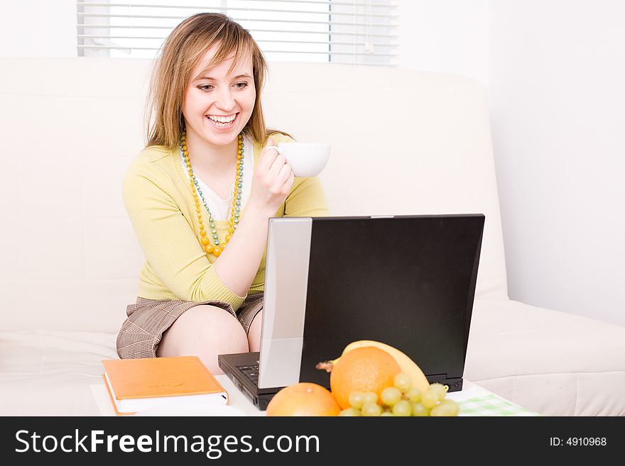 Portrait of smiling woman with laptop / at home