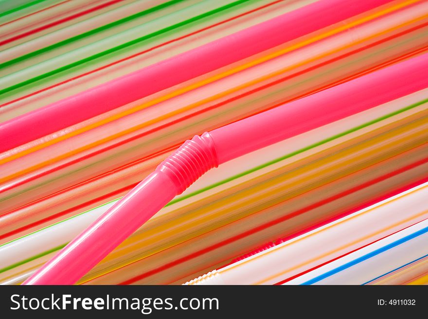 Multi-coloured straws for a cocktail close up