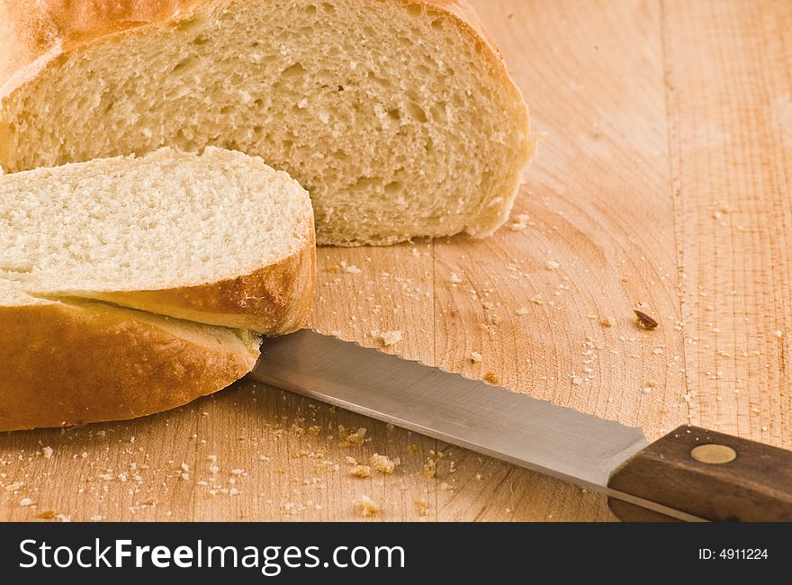 Fresh baked bread sliced on a butcherblock cutting board. Fresh baked bread sliced on a butcherblock cutting board