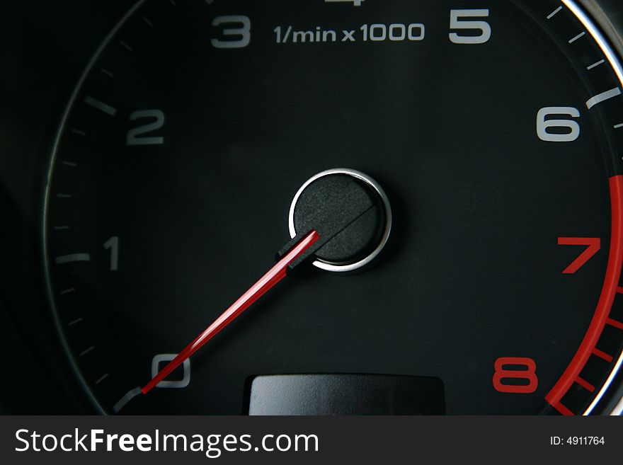 Car tachometer with red arrow