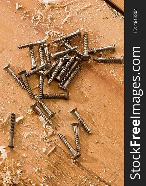 Tools series: some metal screw on the wooden plank