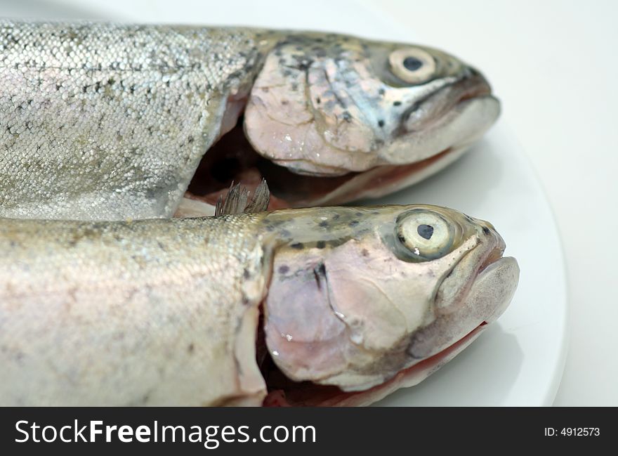 Two raw fresh fishes on a plate