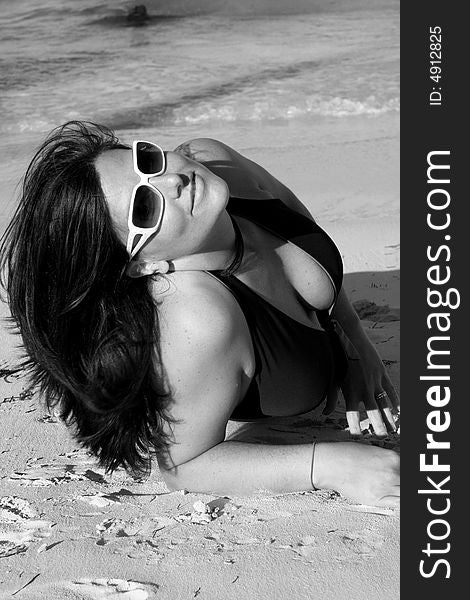Black and white photo of a swimsuit model on the beach. Black and white photo of a swimsuit model on the beach.