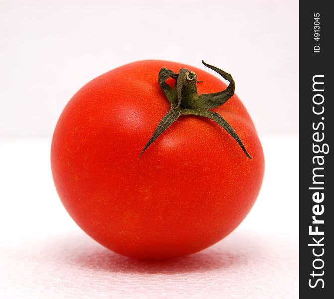 Red tomato on the white background