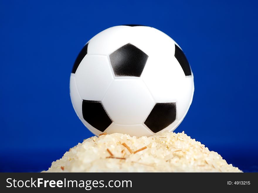 Soccer ball on sand hill