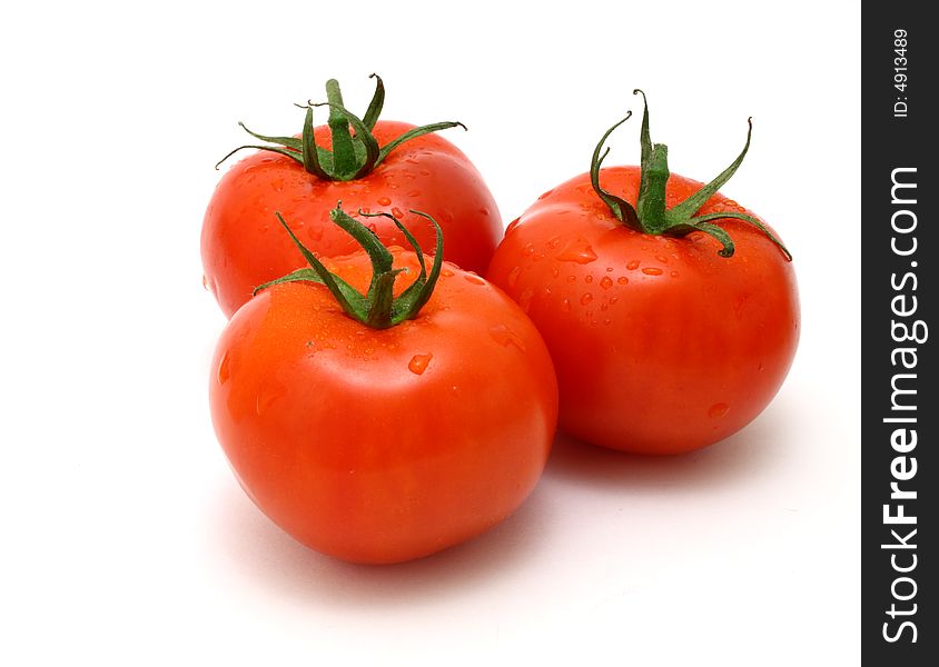 Three fresh and juicy tomatoes over a white surface. Three fresh and juicy tomatoes over a white surface