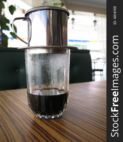 A fresh brewing coffee in a glass.
