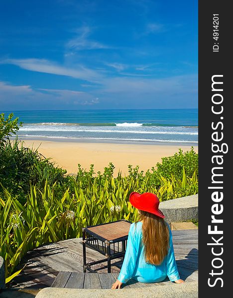 Woman in red hat on the tropical beach