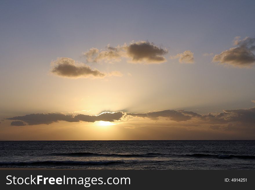 The sun setting over the Pacific Ocean in Maui. The sun setting over the Pacific Ocean in Maui.