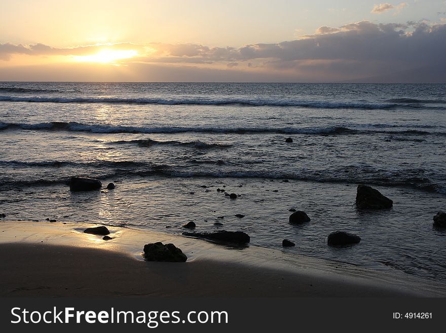 The beach and rock landscape as the sun sets in Maui. Focus on shoreline. The beach and rock landscape as the sun sets in Maui. Focus on shoreline