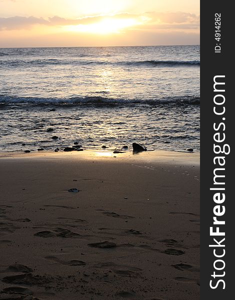 The beach and rock landscape as the sun sets in Maui.  Focus on shoreline. The beach and rock landscape as the sun sets in Maui.  Focus on shoreline