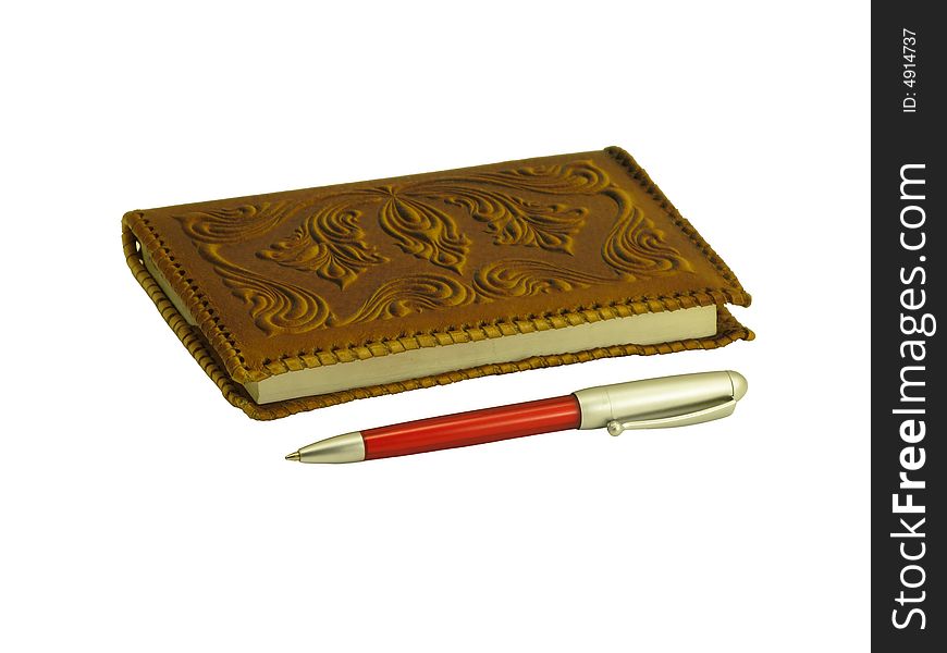 Brown soft leather covered notebook and a pen on a white background