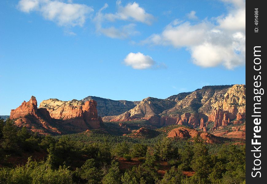 Red rocks of Sedona in the sun with black clouds rolling in. Red rocks of Sedona in the sun with black clouds rolling in.