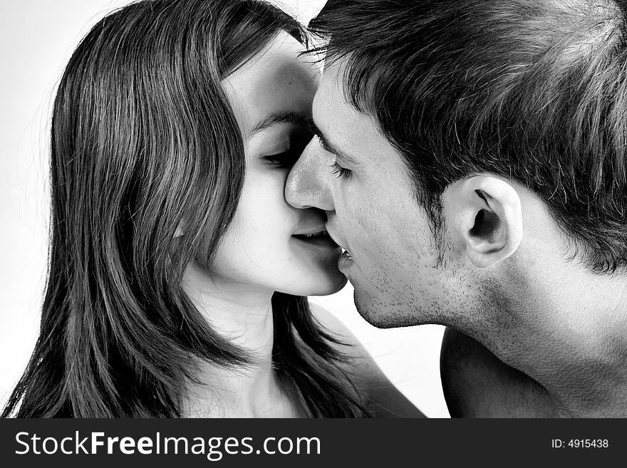 Young adult couple in the studio kissing. Young adult couple in the studio kissing