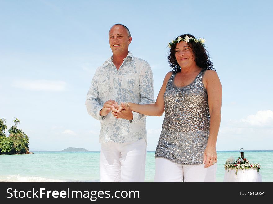 Attractive couple getting married on the beach in Thailand - travel and tourism. Attractive couple getting married on the beach in Thailand - travel and tourism.