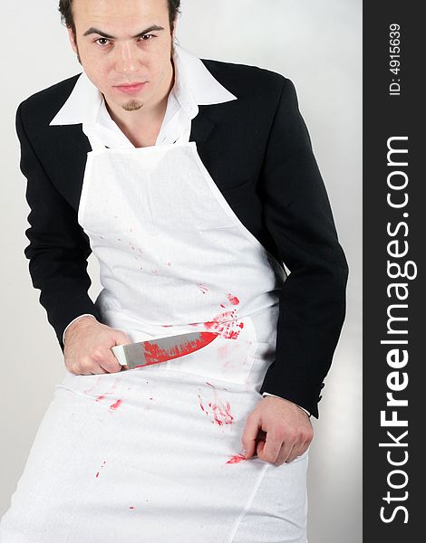 Man with knife and blood on apron. Man with knife and blood on apron