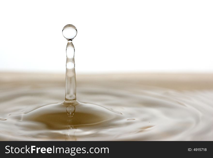 Water drop in bowl of water with brown bowl. Water drop in bowl of water with brown bowl