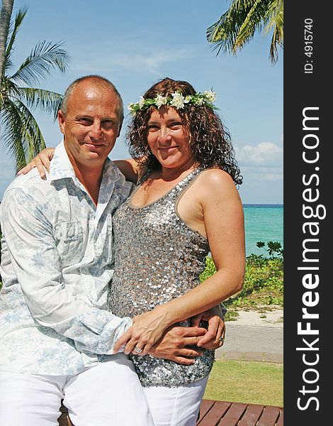 Portrait of a happy couple in an embrace during their tropical destination vacation.