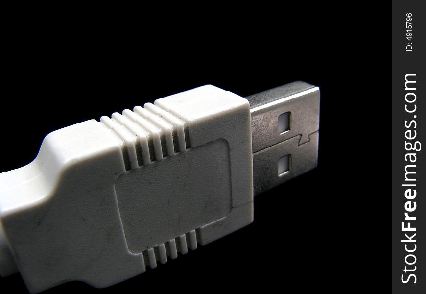 USB cable with plug in detail on black background