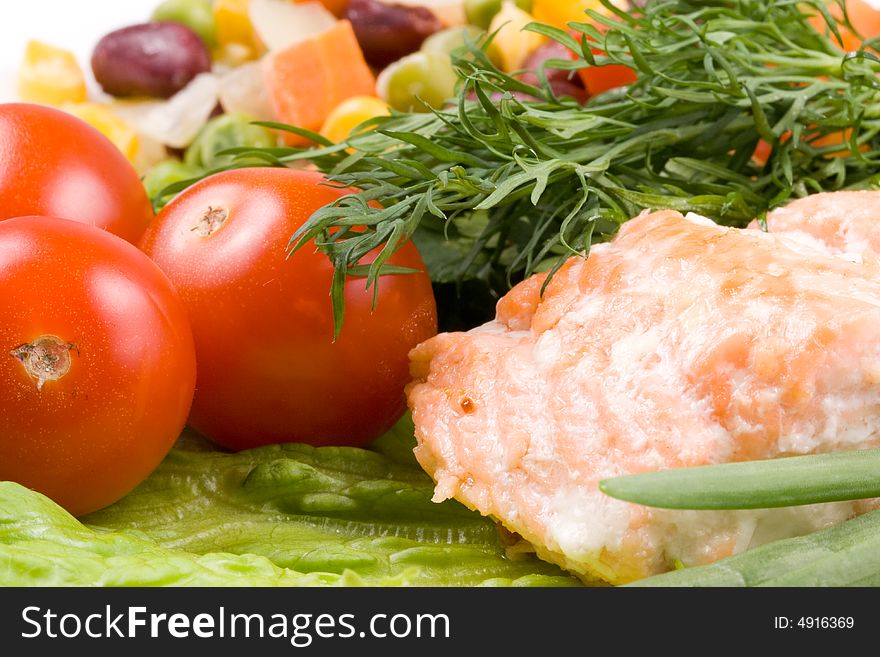 Stake from a salmon with vegetables on a plate