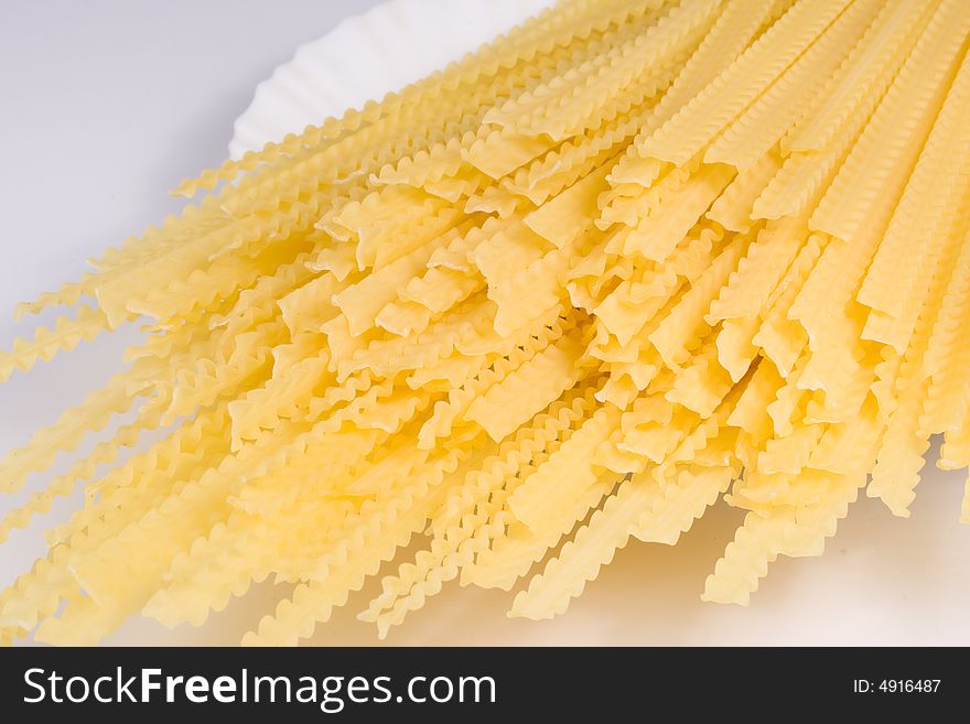 Abstract background from raw italian pasta. Close-up. Abstract background from raw italian pasta. Close-up.