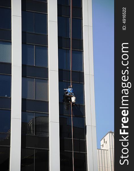 They wash windows in a high office building. They wash windows in a high office building.